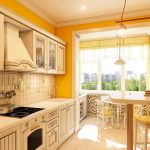 Paredes amarillas y muebles blancos en la cocina.