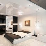 Interior de dormitorio en colores blanco y oscuro.