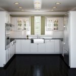 Piso negro y muebles blancos en la cocina.