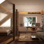 Sillón y mesa con computadora junto a la ventana