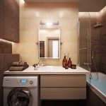 Lavadora debajo del lavabo en el baño.