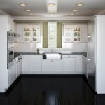 Interior de cocina con paredes blancas y piso negro.