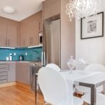 Una combinación de un delantal azul y muebles de cocina grises.