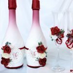 Rosas rojas y blancas en botellas y vasos