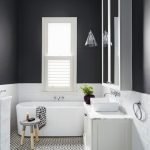 Paredes negras en el baño con una ventana