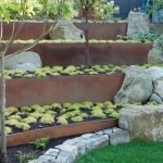 Jardín de flores en capas con cantos rodados