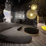 Sillón amarillo en una oscura sala de estar.