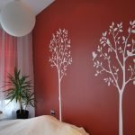 Árboles blancos en una pared roja