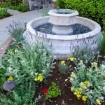 Fuente redonda entre flores