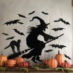 Gato y bruja en una escoba