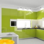 Muebles de color verde claro con encimeras negras.